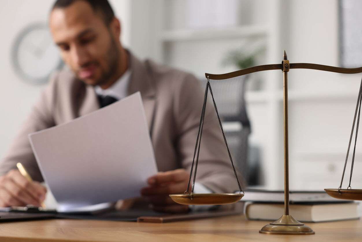 personal injury attorney in Encino Lawyer is sitting on the table and reading