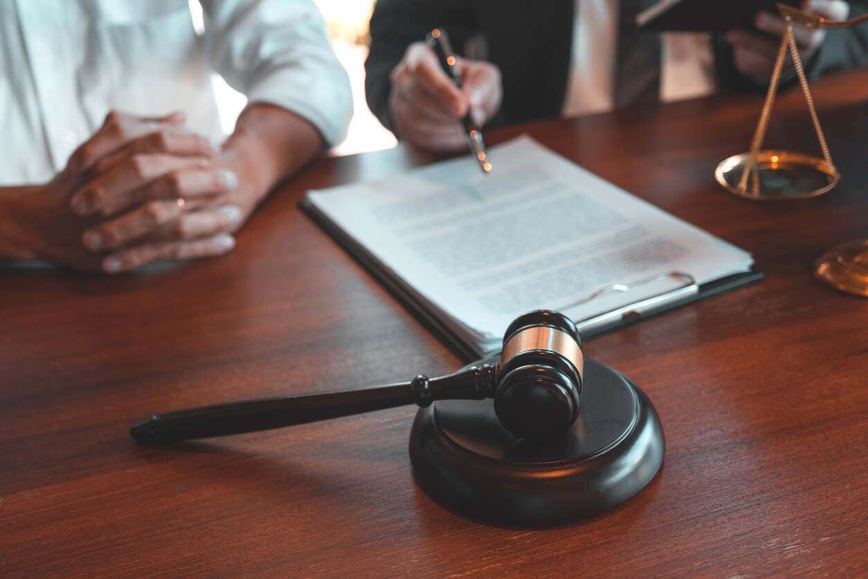 Riverside personal injury lawyer client and lawyer discussing the personal injury case in riverside and document and lawyer gavel on the table