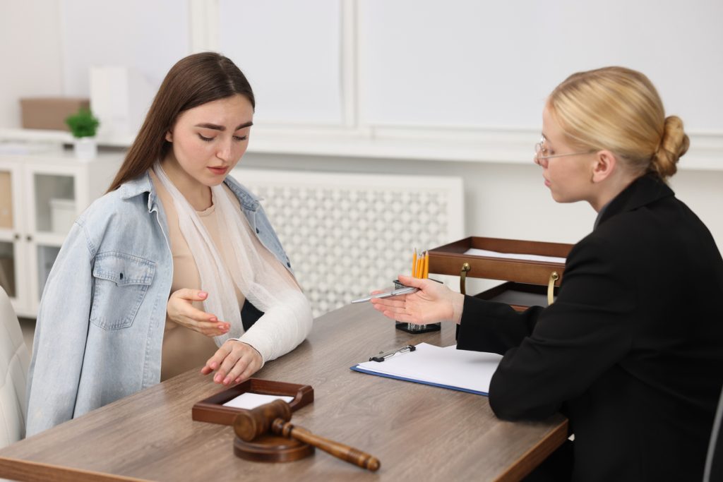 Injured woman having meeting with lawyer for a compensation