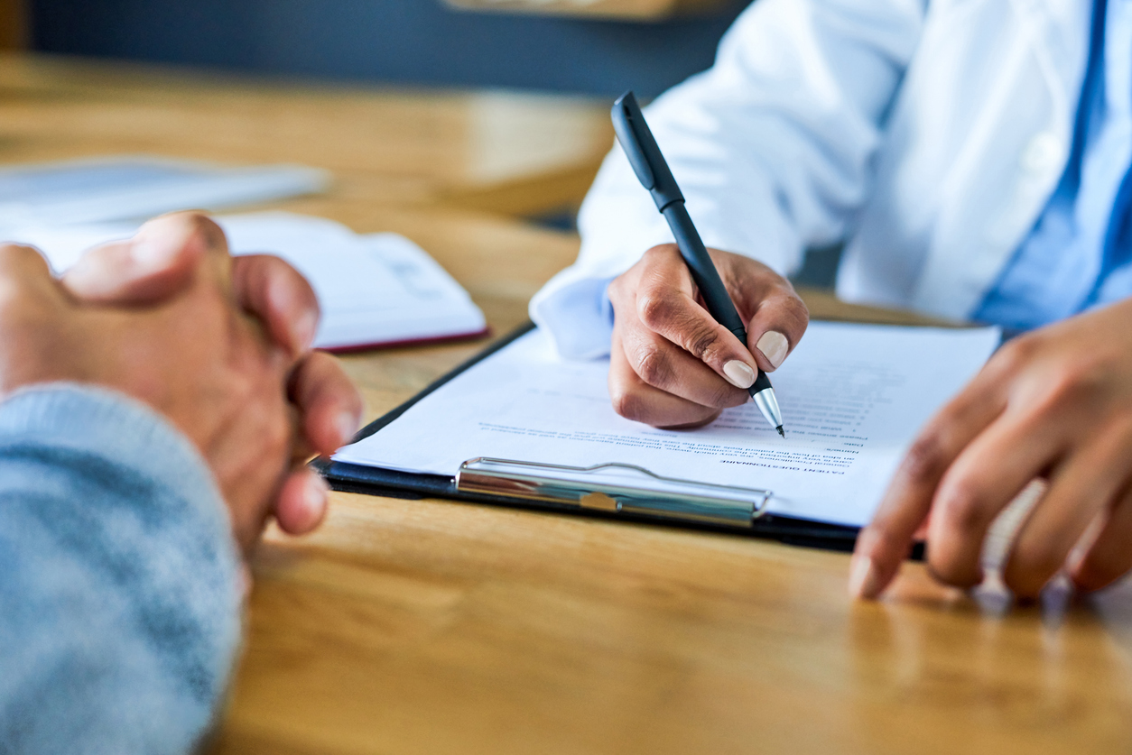 Attorney reviewing and explaining legal documents with a client during a personal injury consultation involving medical and injury related records