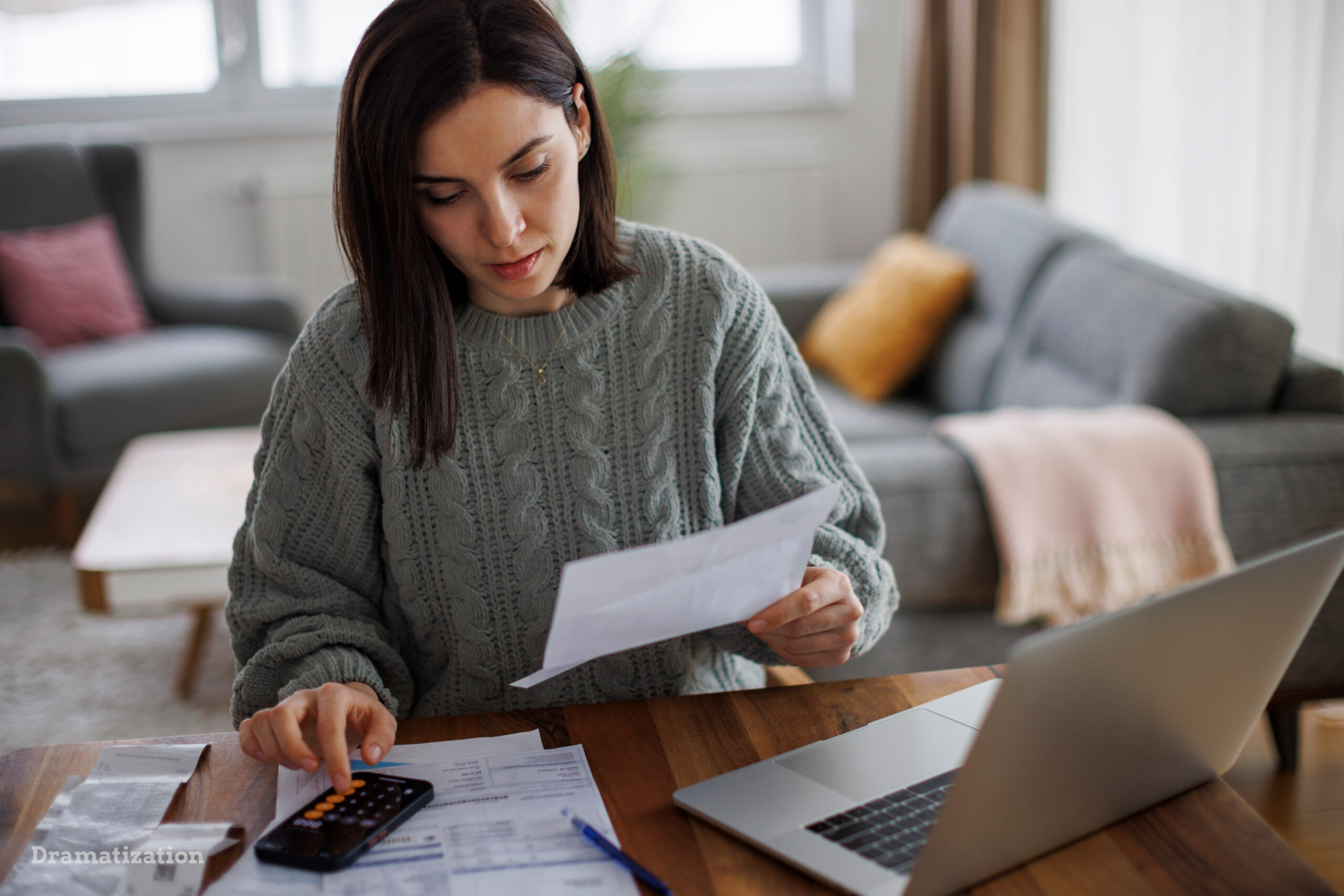 Woman checking her monthly expenses and statements at home