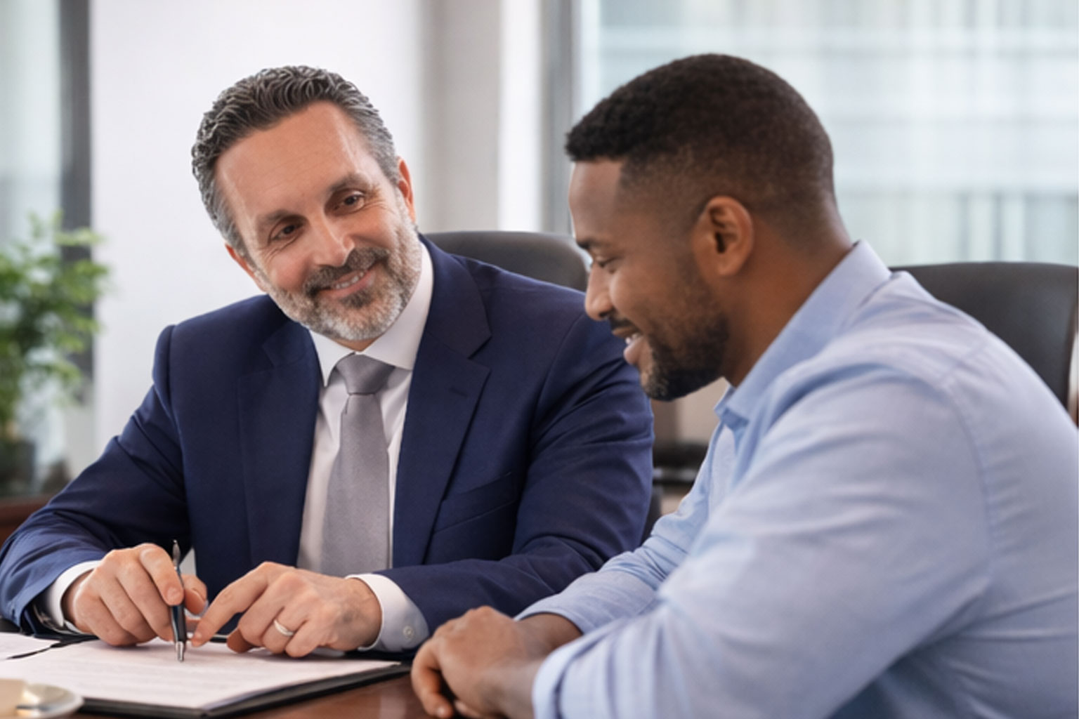 Professional Bark Law Firm team collaborating and reviewing documents in office hallway